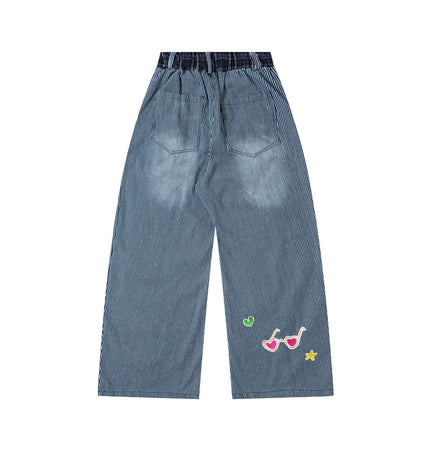 Cartoon Washed Denim Pants - Loose Fit with playful cartoon embroidery and washed stripe finish.