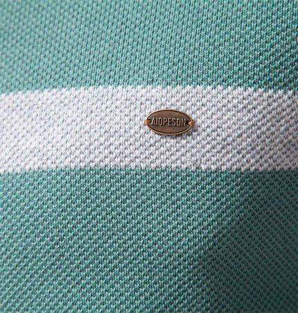 Close-up of the label on the Grozavu Stand Collar Half-Zip Knit Sweater in teal with white stripes.