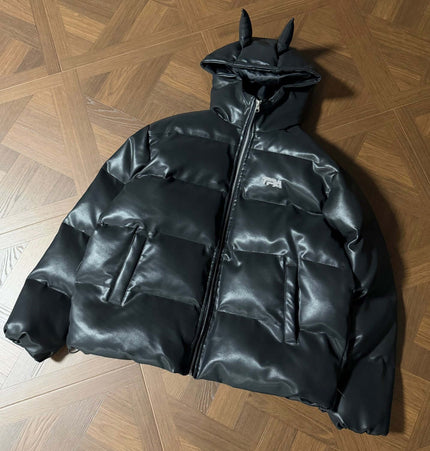 Devil Ears Leather Hoodie Jacket – Loose Fit displayed on a wooden surface, showcasing its unique design and cozy style.