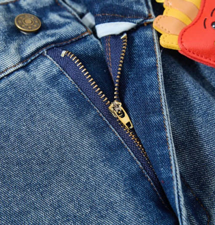Close-up of the zipper and denim fabric of Cartoon Patch College Denim Pants with playful cartoon patches.
