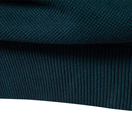 Close-up of the hem and texture of the Stand Collar Half-Zip Knit Sweater in dark color.