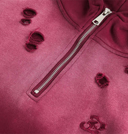 Close-up of the Half-Zip Printed Hoodie – Loose Fit showcasing dark red fabric with distressed details and silver zipper.