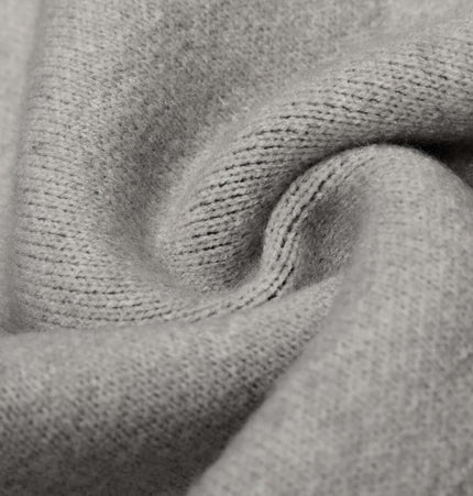 Close-up of soft gray fabric texture for Letter Jacquard Knit Hoodie – Loose Fit showcasing comfort and quality.