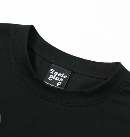 Washed Spray Print TShirt – Loose Fit close-up of neckline showing brand label on black fabric.