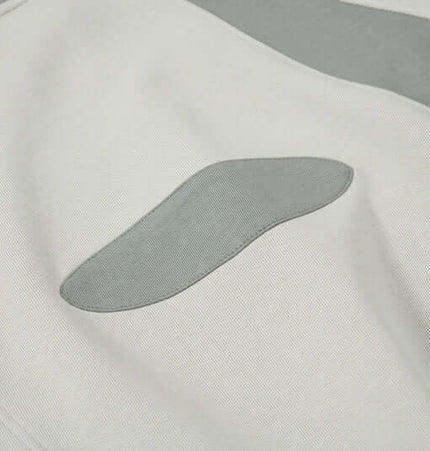 Close-up of the fabric texture and splicing pattern of the Color-Block Hooded Jacket – Loose Fit.