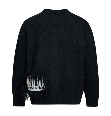 Back view of the Fringe Patchwork Knit Sweater – Loose Fit showcasing fringe detailing and black texture.