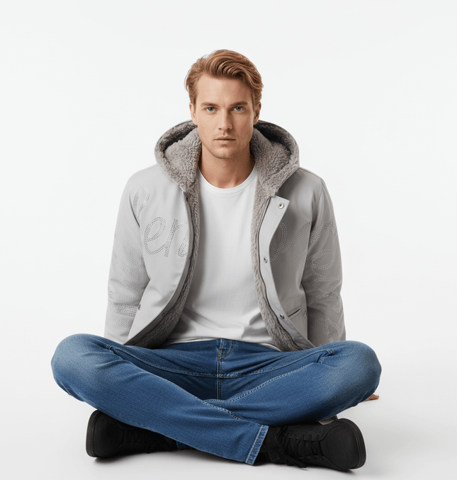 Model wearing the Hawk Embroidered Letter Hooded Coat sitting cross-legged on a white background.