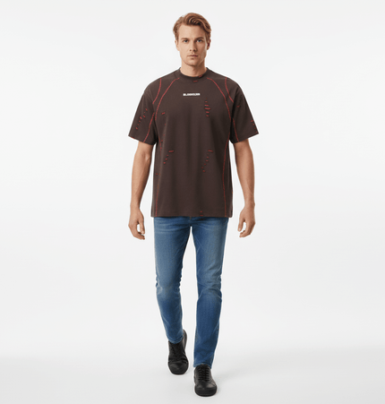 Distressed Short Sleeve TShirt – Loose Fit worn by a model in a casual setting with ripped details and a stylish look.