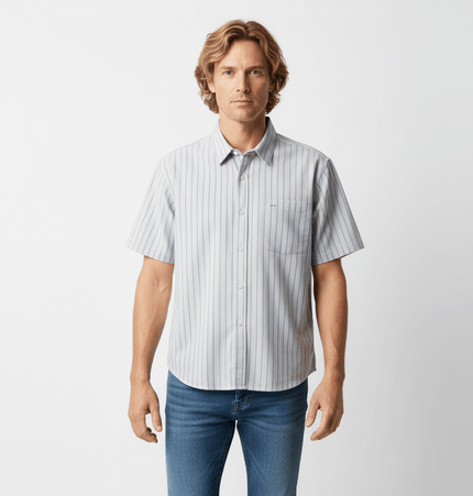 Patch Striped Short Sleeve Shirt - Loose Fit worn by a man, featuring a light blue and white striped pattern.