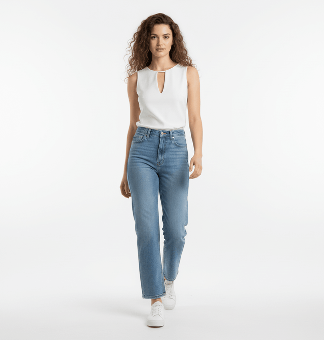 A model showcasing a VNeck Sleeveless Crop Top - Slim Fit with high-waisted jeans, walking confidently.
