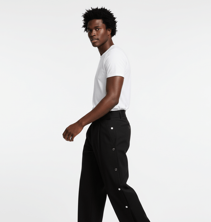 Man wearing Wide Leg Pleated Plaid Trousers with a white t-shirt, showcasing a relaxed streetwear style.
