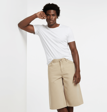 Model wearing Elastic Waist Denim Shorts – Straight Fit with a white t-shirt, showcasing a relaxed summer style.