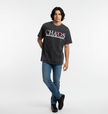 Cross Print Vintage TShirt – Loose Fit worn by a model standing casually in a gray shirt with bold lettering.