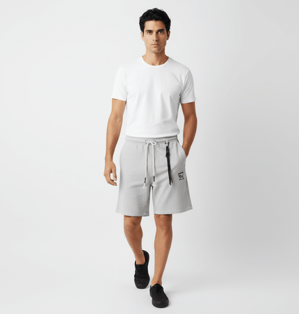 A man wearing Straight Leg Drawstring Shorts – Loose Fit and a white t-shirt, walking confidently in a casual setting.