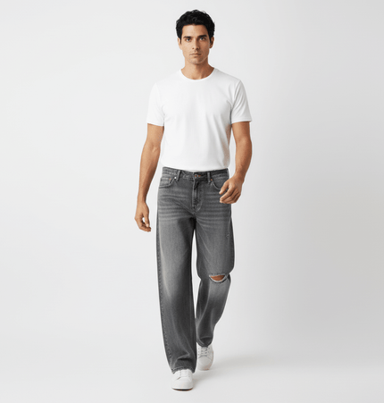 Model wearing Washed Distressed Denim Pants with a white t-shirt, showcasing casual street-style appeal.