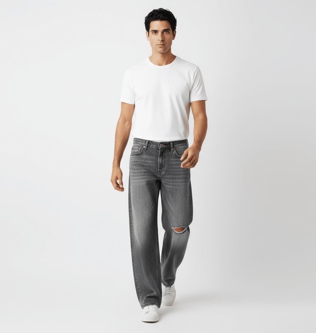 Model wearing Washed Distressed Denim Pants with a white t-shirt, showcasing casual street-style appeal.