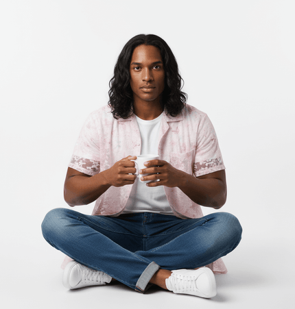 Model wearing a Butterfly Jacquard Printed Shirt, sitting cross-legged and holding a mug, showcasing its retro style.