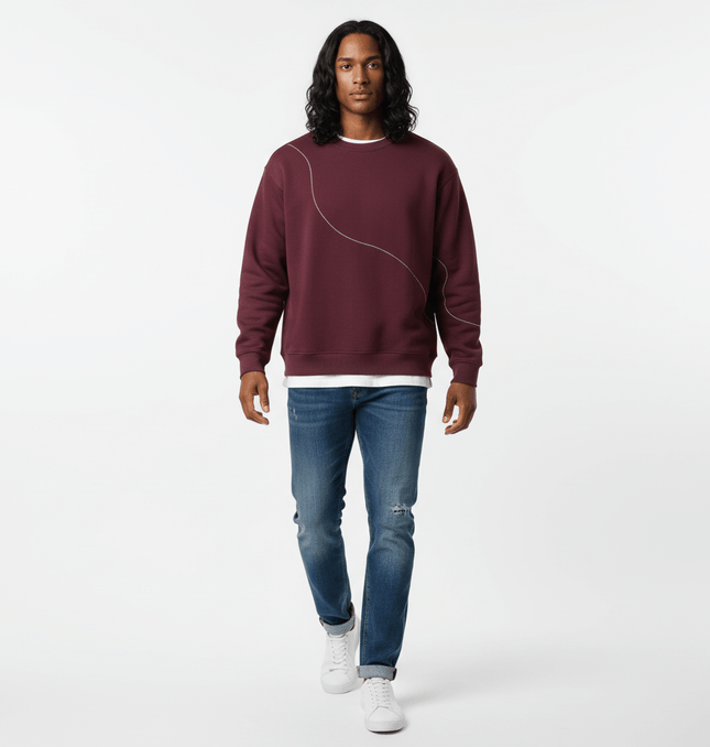 Round Neck Letter Print Hoodie – Loose Fit modeled by a man in a maroon sweatshirt and blue jeans.