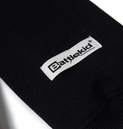 Close-up of the Battlekid label on a black hoodie sleeve, showcasing premium quality and design.