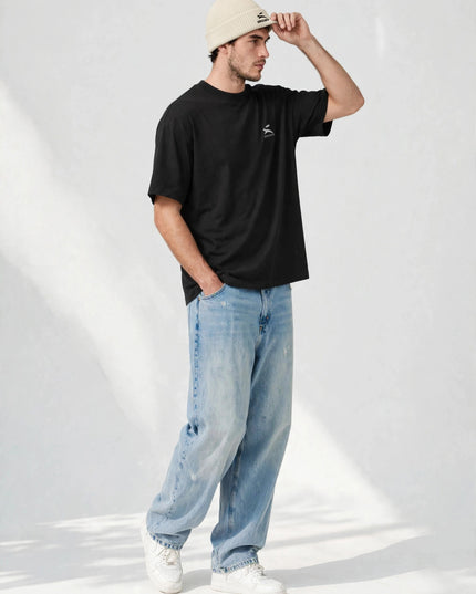 Model adjusting the ribbed-knit fisherman beanie in a studio shot