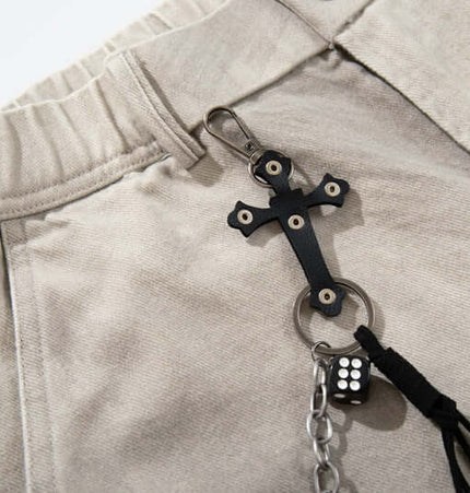 Straight Leg Patchwork Denim Jeans featuring a unique black cross charm detail on waistband with chains and tassels.