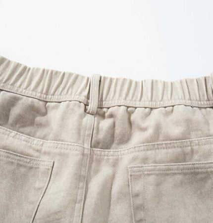 Back view of Straight Leg Patchwork Denim Jeans showcasing elastic waistband and pockets.