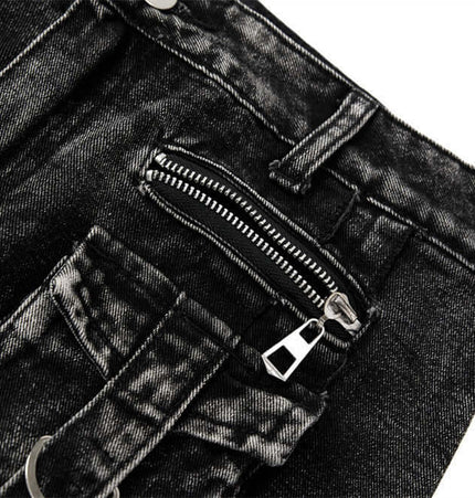 Close-up image of Belted Distressed Cargo Jeans featuring a zippered pocket and rugged black denim texture.