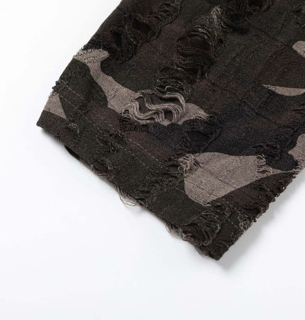 Detail of the fabric featuring a textured, frayed edge in a dark camouflage pattern.