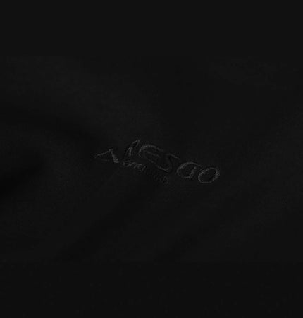 Close-up of the Patchwork Embroidered Hoodie – Loose Fit showcasing its stylish black fabric texture.