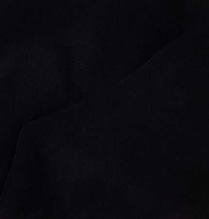 Close-up of the fabric texture used in the Cross Embroidered Hoodie – Loose Fit, highlighting its soft black material.