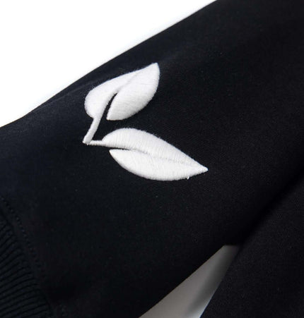 Cross Embroidered Hoodie – Loose Fit featuring unique leaf embroidery detail on the sleeve.