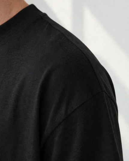 Macro of the organic cotton knit and hem on the black oversized tee