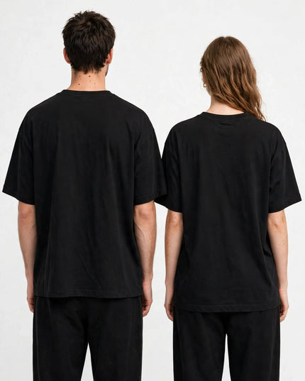 Black boxy tee worn front view, side-seamed oversized cut