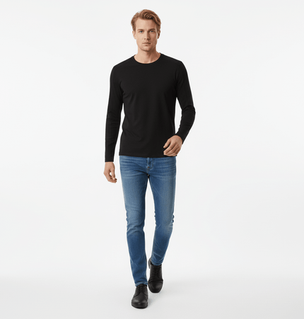 Man wearing Bottom Knit Long Sleeve Pullover in black with blue jeans and black shoes, perfect for casual outings.