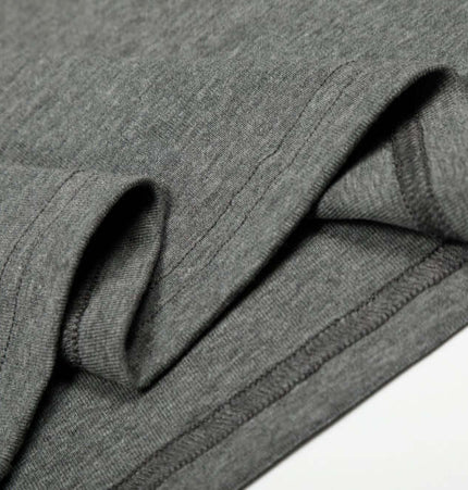 Close-up of the soft fabric details of the Bottom Knit Long Sleeve Pullover in medium gray.