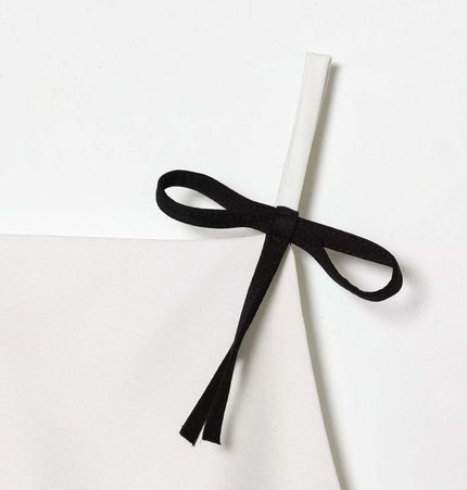 Casual Bow Detail Strap Top – Slim Fit showing a cute black bow detail on a solid white strap.