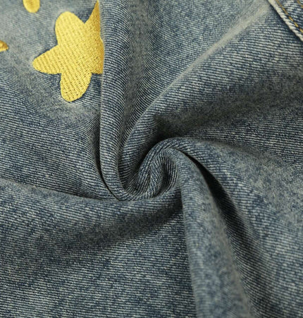 Close-up of Casual Cartoon Embroidered Denim Pants featuring playful cartoon embroidery and soft denim fabric.
