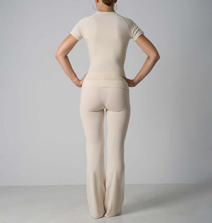 Back view of a woman wearing a Casual Fit Cotton Jersey Yoga Set featuring a crop top and flare pants.