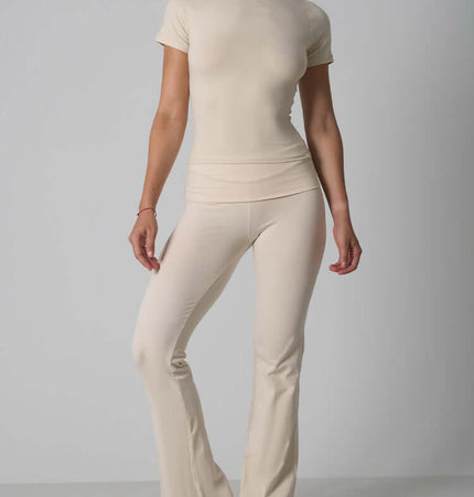 Casual Fit Cotton Jersey Yoga Set featuring a short sleeve crop top and high-waist long flare pants in beige.