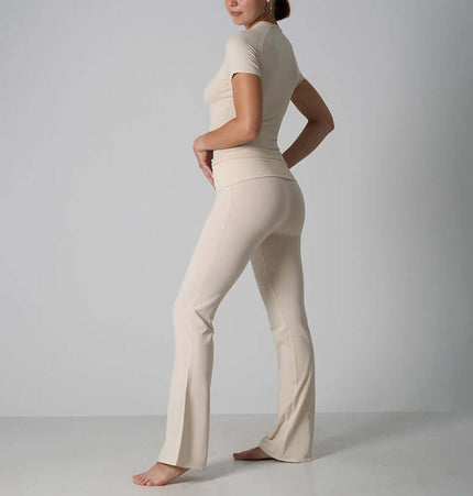 Casual Fit Cotton Jersey Yoga Set showcasing a stylish woman in a beige short sleeve crop top and high-waist flare pants.
