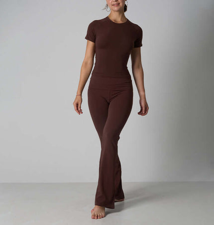 Casual Fit Cotton Jersey Yoga Set worn by a model, showcasing a short sleeve crop top and high-waist flare pants.