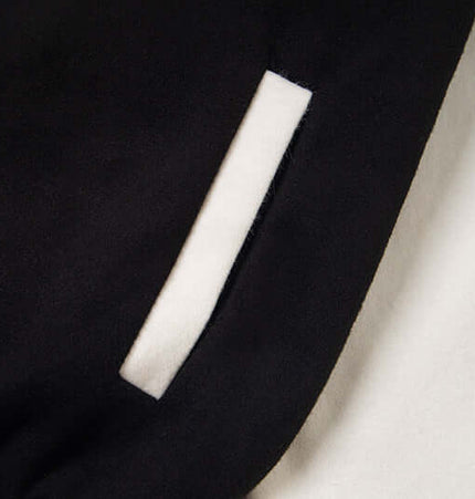 Close-up of the pocket detail on the Cat Embroidered Baseball Jacket - Loose Fit, showcasing its stylish design.