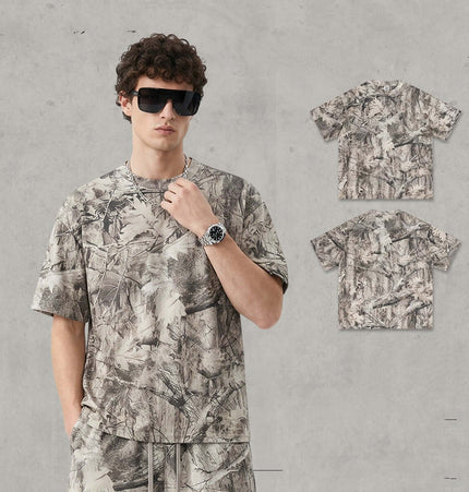 Camouflage Drop-Shoulder TShirt – Loose Fit worn by a model featuring a bold branch camouflage pattern.