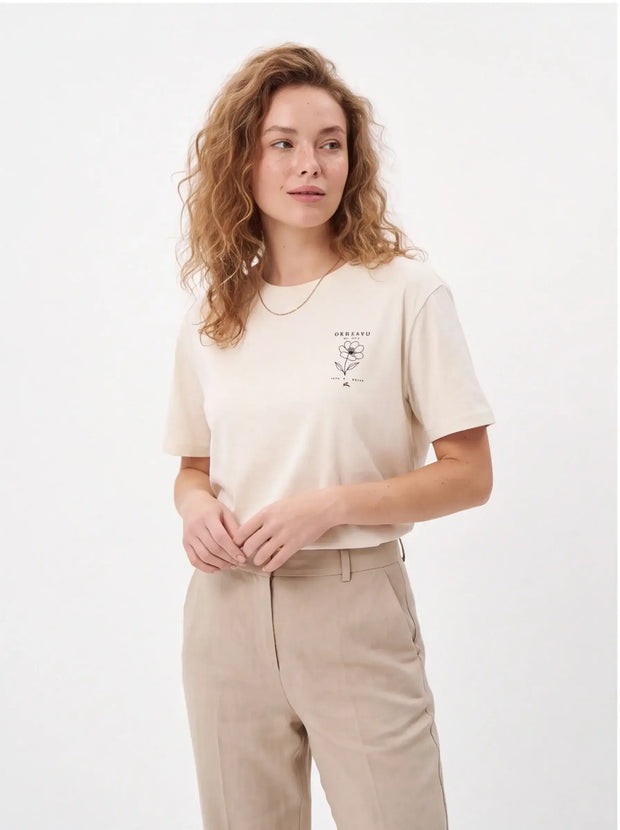 Tailored Monochrome Tee Vintage White — three-quarter lifestyle angle highlighting the clean double-needle sleeve hem