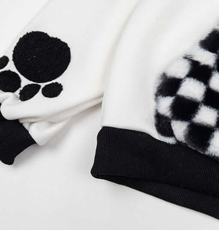 Detail of the Checkered Fleece Hoodie with Rabbit Ears showing its stylish black and white patchwork sleeves.