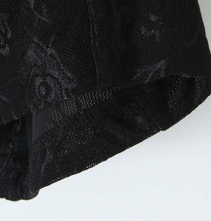 Close-up of the fabric detail on a Cinched Lace Fishbone Tank Top showcasing lace texture and black color.