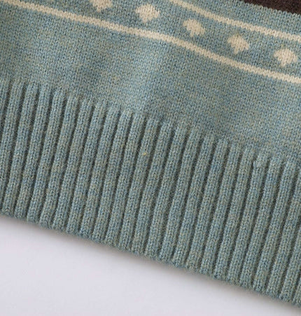 Close-up of the ribbed hem of a Color-Block Fair Isle Sweater - Loose Fit in soft blue fabric.