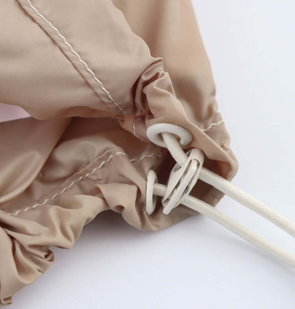Detail of the Color Block Jacket and Long Pants Set showing drawstring closure and stitching.
