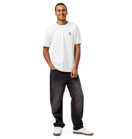 Model wearing Cotton Heritage MC1082 Premium Tee in white, paired with dark jeans and sneakers.