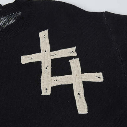 Close-up of the Cross Jacquard Knit Sweater – Loose Fit showing the unique jacquard pattern and soft texture.